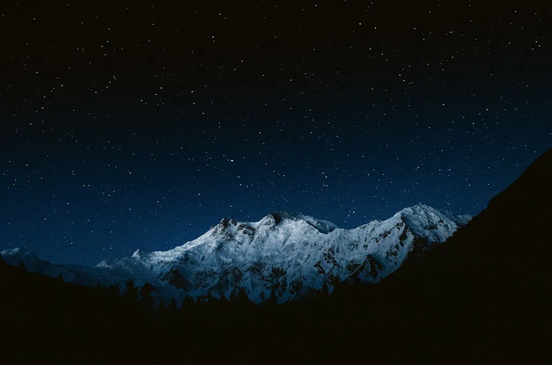 Snow-capped peak under a night sky full of stars